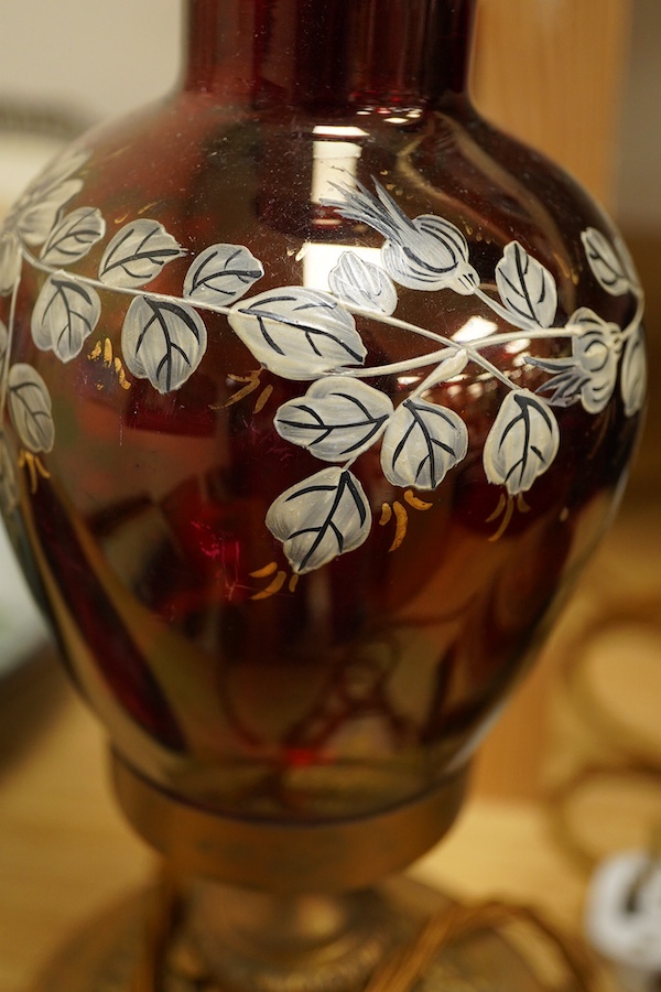 A pair of ruby glass, enamel and gilt metal table lamps, 57cm